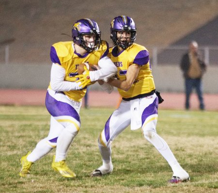 Ty Chambers hands off to Andrew Moench as the Tigers crushed Frontier High School 56-21.